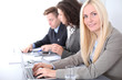 © rogerphoto - A group of business people at a meeting on the background of office. Focus on a beautiful blonde