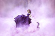 © kharchenkoirina - Lady in a luxury lush purple dress swirls in the smoke,fantastic shot,fairytale princess is walking in the autumn forest,fashionable toning,creative computer colors