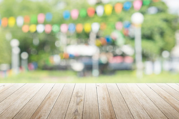 Wall Mural - Empty wooden table with blurred party on background