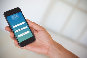 Poster - composite image of womans hand holding black smartphone