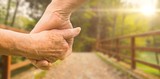 Fototapeta  - Composite image of elderly couple holding hands