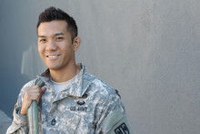 Young Ethnically Ambiguous American Soldier With Backpack And Copy Space On The Right 