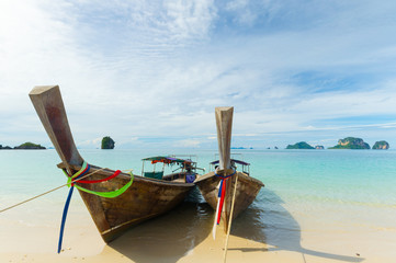 Wall Mural - Longtail boats floating on transparent water