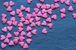 Candy hearts on black marble abstract background
