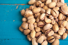 Salted Pistachios On A Blue Wooden Table