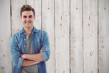 Wall Mural - Composite image of smiling creative businessman by his desk