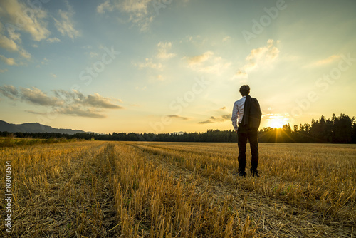 Fotografie, Obraz Businessman in elegant suit with his jacket hanging over his sho
