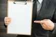 © comzeal - Businessman showing blank document