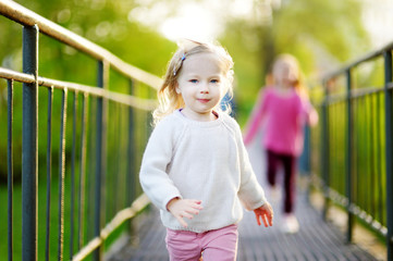 Two funny little girls running with joy and happines