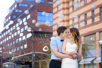 Wall Mural - Bride and groom walking around among the houses and buildings