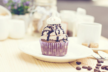 Chocolate Cupcake with chocolate frosting on the table