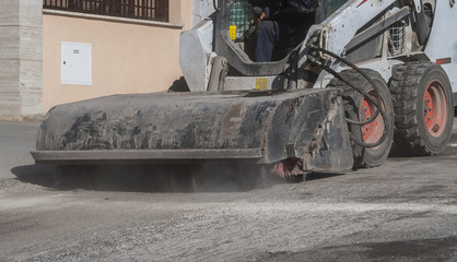 Sweeper attachments mini excavator. The sweeper sweeps, collects and dumps dirt and debris.