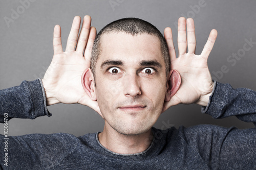 Foto curiosity and hearing concept - playful young man emphasizing the size of his ea