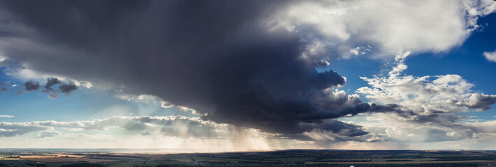 Wall Mural - Panorama of pre storm clouds in the blue sky. Five minutes before rain