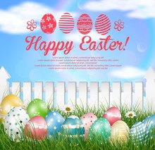 Easter Eggs On A Grass Field With Flower On  Wooden White Fence Background