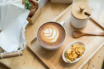 Wall Mural - hot latte art  with cactus in coffee shop on table wooden