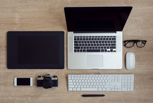 Business workplace with laptop and gadgets on wooden background
