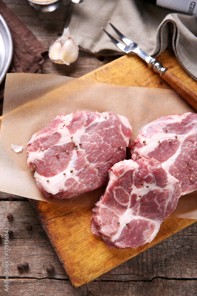 Marbled beef steak and spices on wooden background