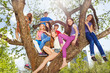 © Sergey Novikov - Teenagers sit together on tree benches in the park