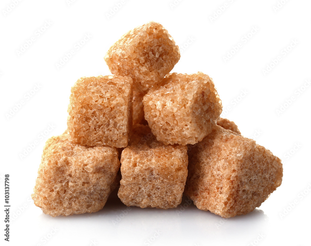 Pile of brown sugar cubes isolated on white background