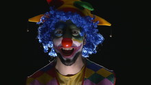Young Hilarious Evil Clown Making Scary Faces
