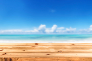 Wall Mural - top of wood table with blurred sea and blue sky background - empty ready for your product display mo