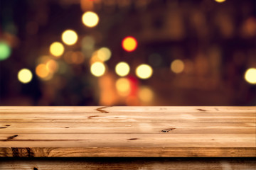 Empty wooden table for product placement or montage with focus to the table top, blurred bokeh background .