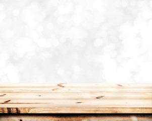 Wall Mural - empty wood table ready for your product display montage. abstract lights gray and white bokeh blurre
