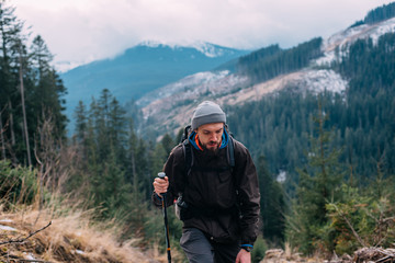 Wall Mural - caucasian male hiking in mountains