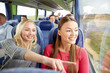 © Syda Productions - happy young women riding in travel bus