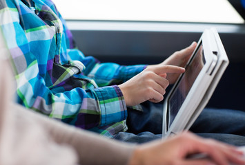 Poster - close up of boy with tablet pc in travel bus