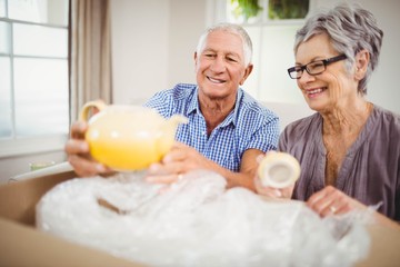 Senior couple unpacking a cardboard box