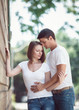 © anoushkatoronto - Portrait of beautiful touching romantic couple man woman in love on spring summer day outside hugging, kissing, looking away from camera, toned with Instagram filters, film effect, movie shot frame