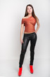 © sandyche - beautiful slim girl in leather pants and red high-heeled shoes