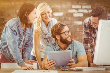 Poster - Composite image of happy business people using digital tablet