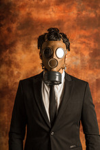 Risky Business. Bearded Man Dressed With A Suit Wtih A Mask Gas