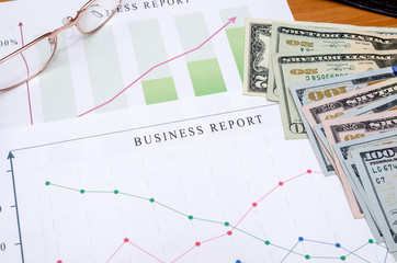 financial data concept with pen and glasses