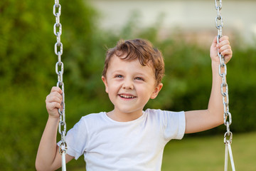 happy little boy playing on playing on the playground
