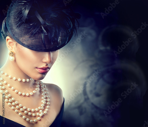 Fototapeta na wymiar Retro woman portrait. Vintage style girl wearing old fashioned hat