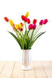 Fototapeta Tulipany - Red and Yellow and Pink tulips in pot on wood texture isolated o