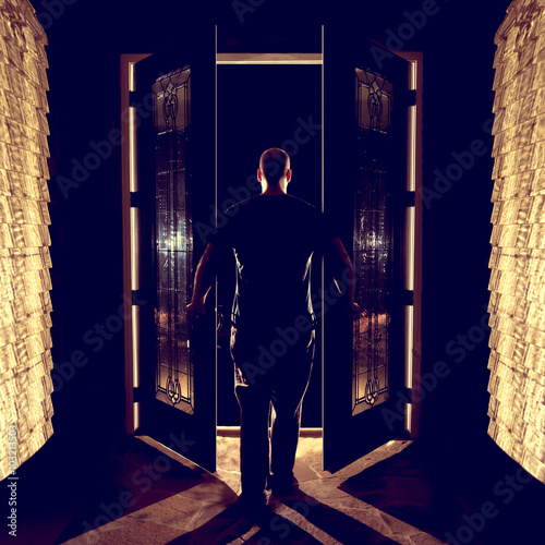 Man opening closing front double entryway doors with glass in foyer ... Man opening closing front double entryway doors with glass in foyer ...