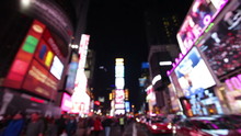 New York City, Times Square, Manhattan Background Out Of Focus With Blurry Unfocused City Lights And Billboards. City At Night With Cars And Pedestrians People Walking.