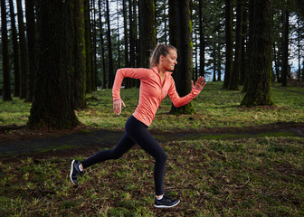 girl running in formation in forest in pink shirt