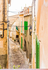 Fototapete - Alleyway of a old rustic village with mediterranean houses