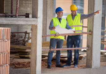 Wall Mural - Male architects show building place to colleague