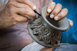 close up potter artist working on clay pottery sculpture fine ar
