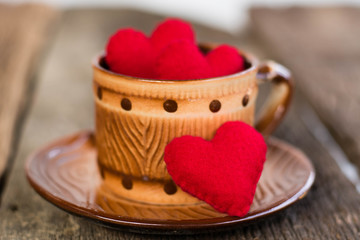 Red heart on a glass coffee set on old wooden