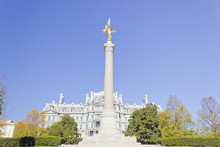 View Of The First Division Monument Crowned By The Gilded Bronze Victory Statue (Winged Victory) With The Eisenhower Old Executive Office Building Behind, President's Park, Washington DC