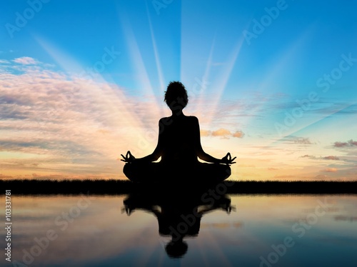 Obraz na plátně Silhouette of a girl practicing yoga