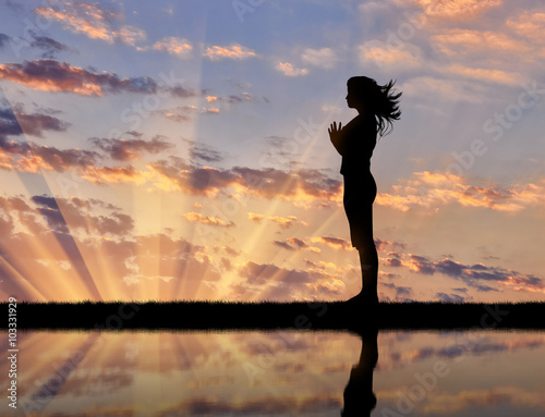 Obraz na plátně Silhouette of a girl practicing yoga